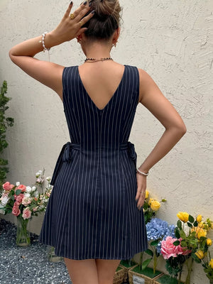 Navy striped tie-waist a-line dress with V-neck and sleeveless design.