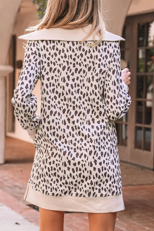 Leopard print zip-up collar mini dress with long sleeves and a cream hem.