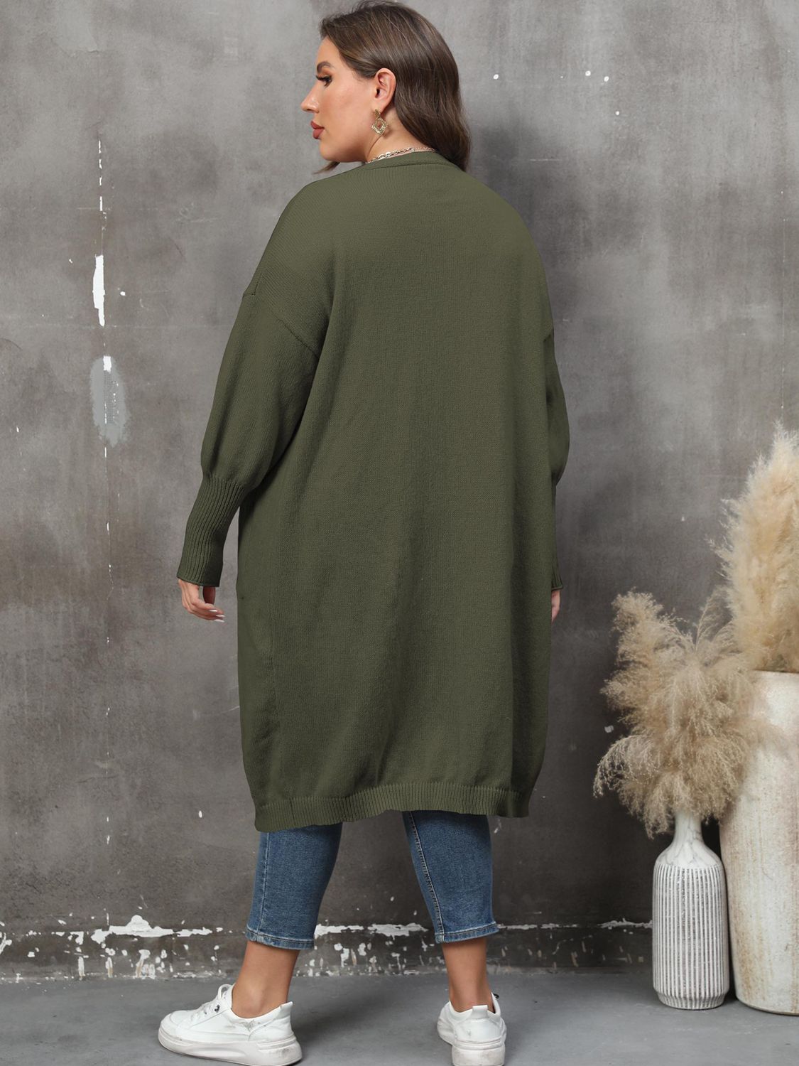 Oversized knit duster cardigan in army green with long sleeves and ribbed cuffs.