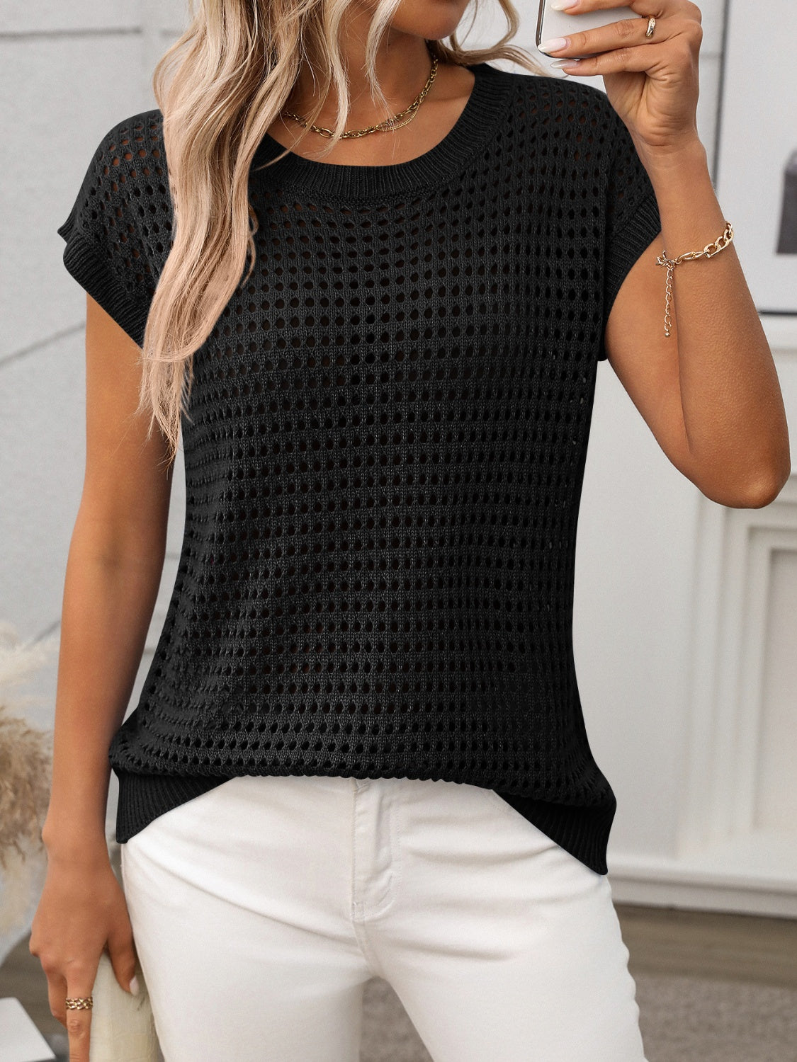 Black openwork knit crewneck top with short sleeves and a relaxed fit.
