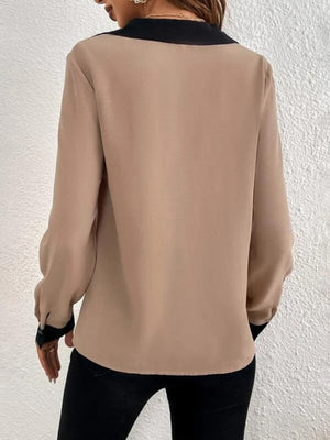 Camel V-neck blouse with black contrast collar and cuffs, long sleeves.