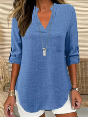 Textured blue maternity shirt with notched V-neck, roll-tab sleeves, and curved hem.