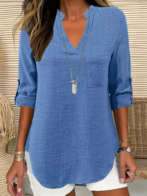 Textured blue maternity shirt with notched V-neck, roll-tab sleeves, and curved hem.
