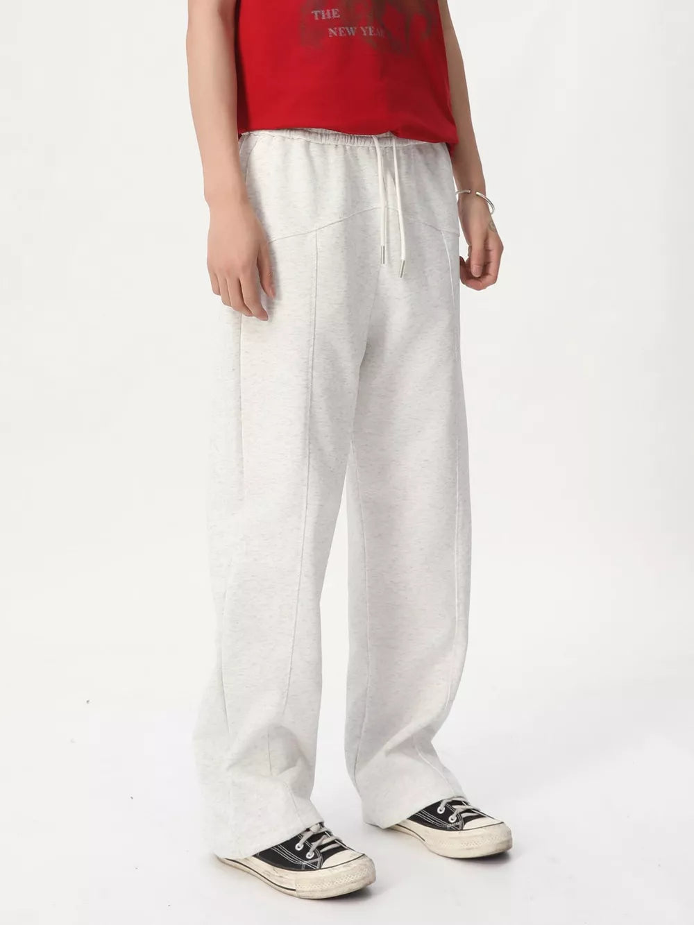 Cream cotton drawstring sweatpants with wide legs and a tailored fit.