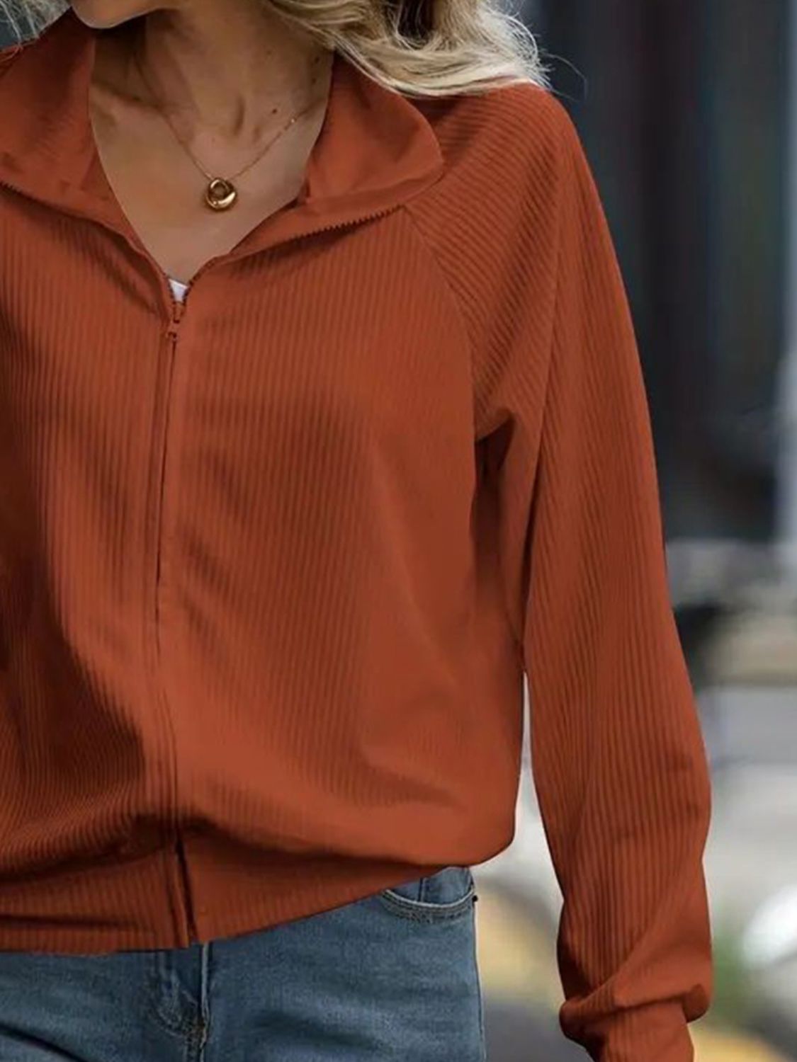 Textured ribbed raglan zip-up jacket in terracotta with a stand-up collar.