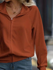 Textured ribbed raglan zip-up jacket in terracotta with a stand-up collar.