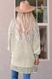 Textured puff sleeve open cardigan in cream with gray trim and cuffs.