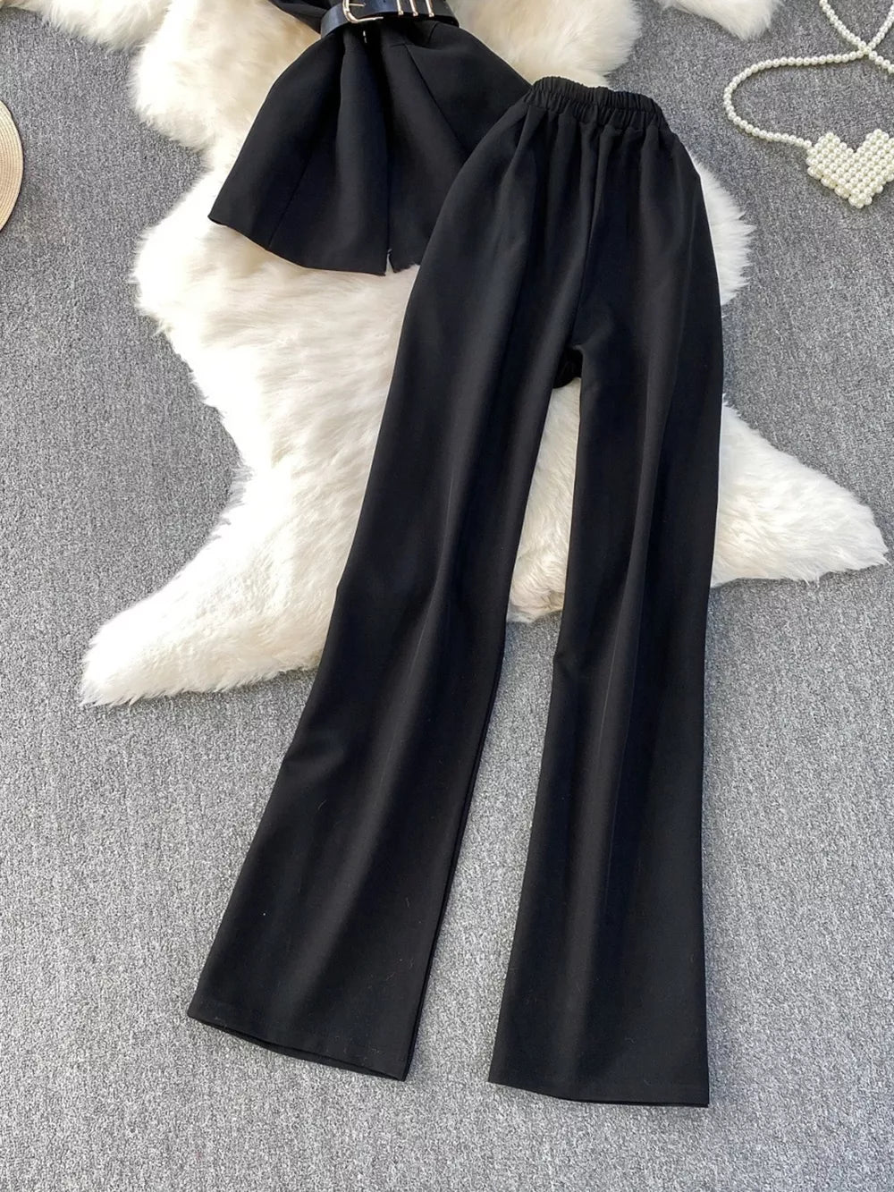 Black belted two-piece set with wide-leg pants and pockets.