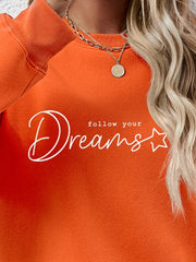 Dreams Scripted Oversized Sweatshirt in Pumpkin orange with white text detail.