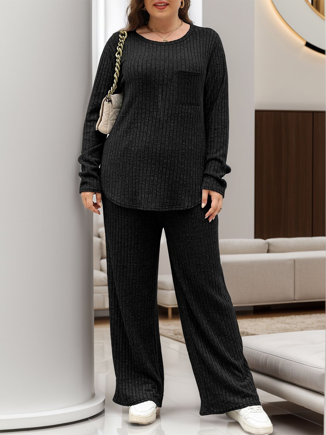 Black ribbed knit lounge set with long sleeves, crew neck, chest pocket, and wide-leg pants.