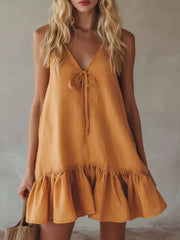 Turmeric tie-front mini dress with V-neck and ruffle hem.