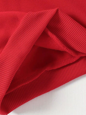 Red baby hoodie detail showing ribbed cuffs and soft fleece lining.