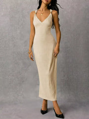 Ivory ribbed midi dress with V-neck and crisscross strap detail.