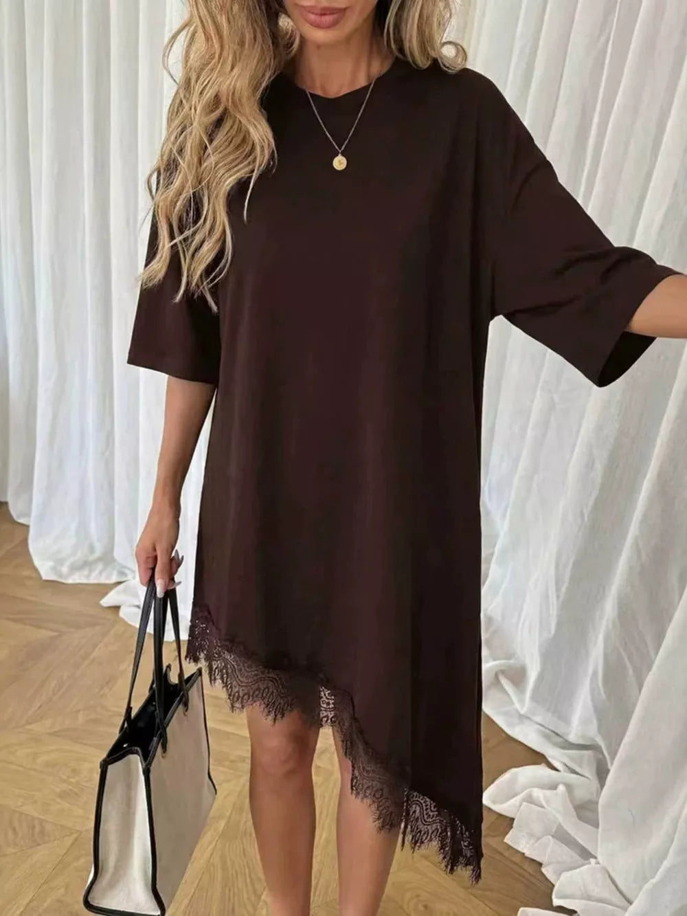 Chocolate asymmetrical t-shirt dress with lace trim hem and short sleeves.