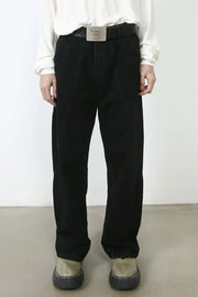 Dark denim trousers with sculpted seams and a relaxed fit.