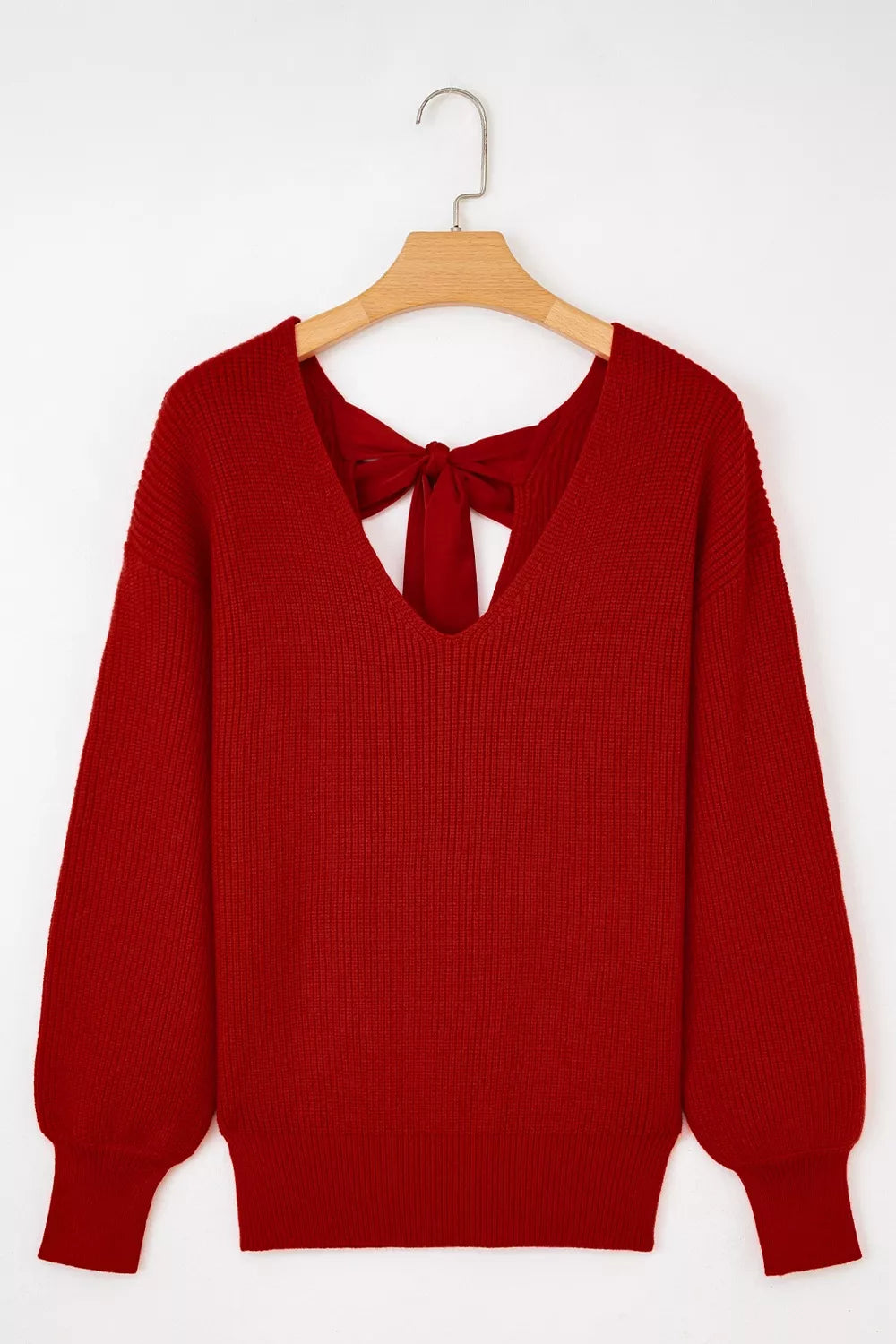 Red knit sweater with backless detail and bow tie accent