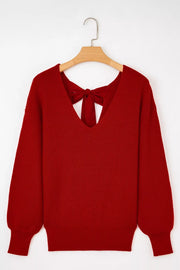 Red knit sweater with backless detail and bow tie accent