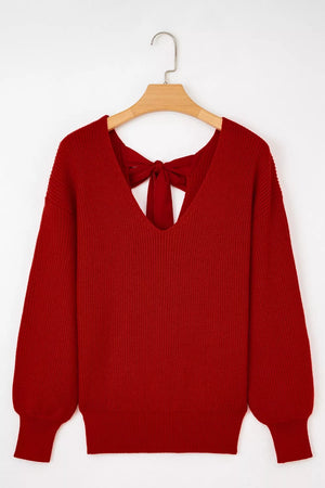 Red knit sweater with backless detail and bow tie accent