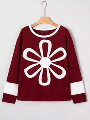 Burgundy long-sleeve top with white flower patch and sleeve bands.