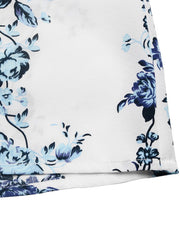 White romper with blue floral print, showing fabric detail and hem.