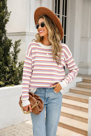 Pastel stripe relaxed knit sweater with crew neck and long sleeves.