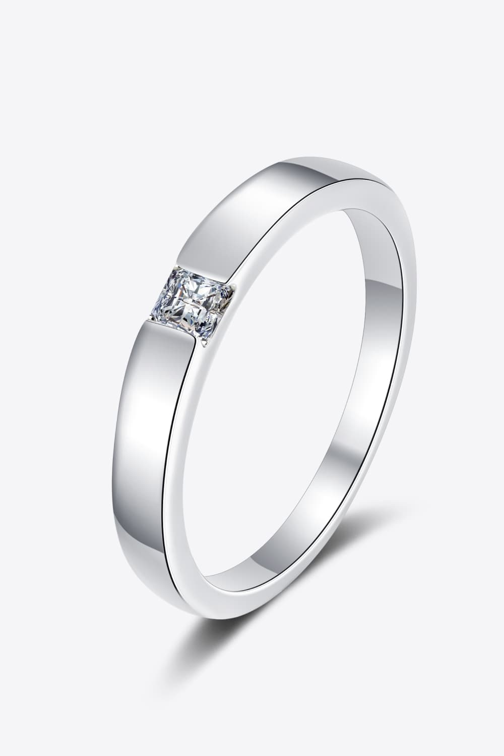 Silver band ring with a square-cut solitaire diamond accent.