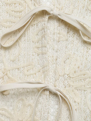 Delicate floral lace tie-front shirt in ivory with cutout details and ribbon ties.