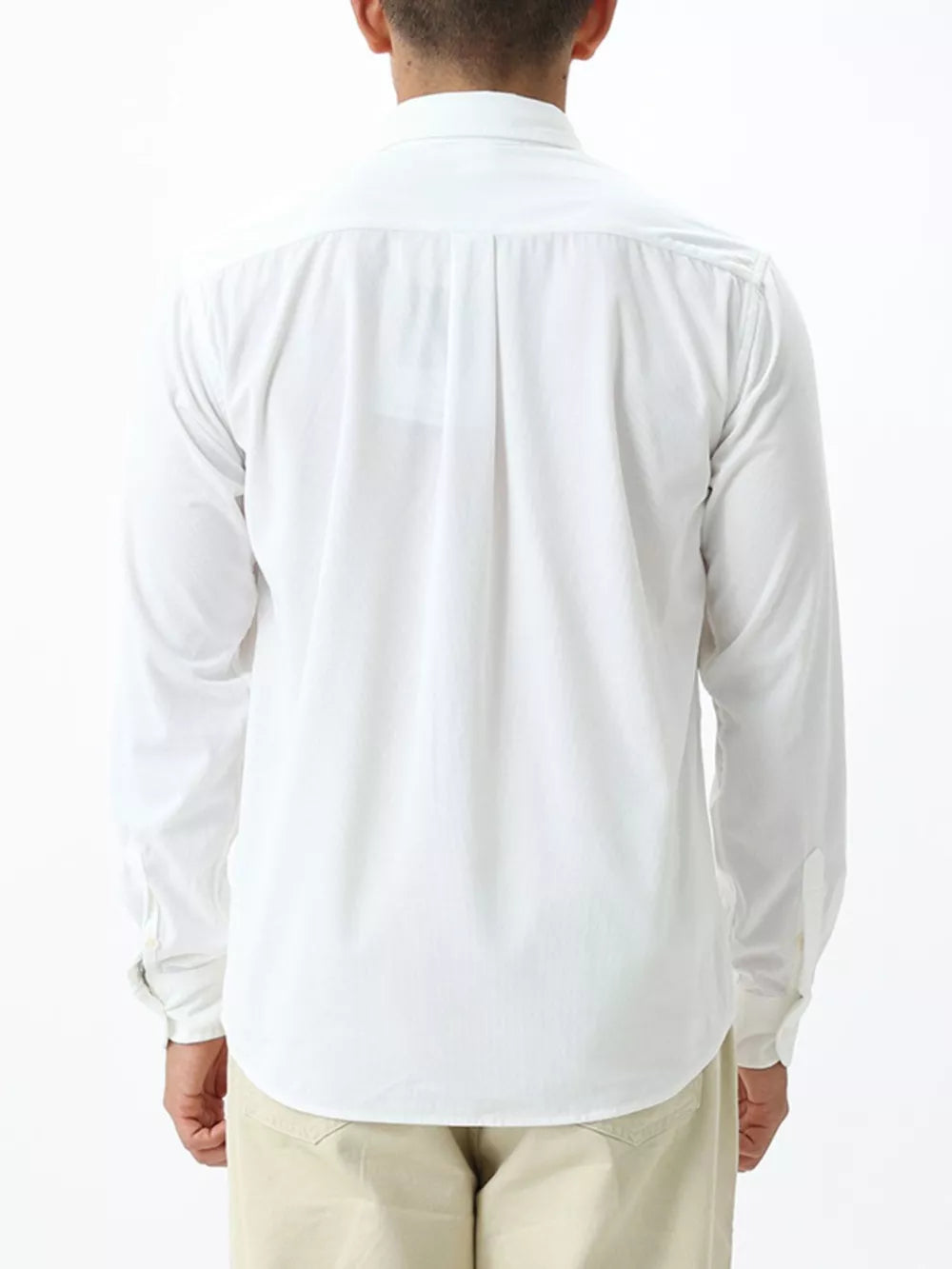 White long sleeve buttoned shirt with back pleats and cuffed sleeves.
