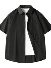 Black short sleeve button-up shirt with pocket, worn over a white t-shirt.