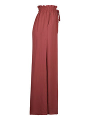 Ruffled waist palazzo trousers in rust with a drawstring and wide leg.