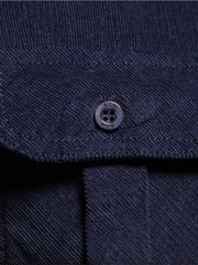 Indigo corduroy utility shirt with button-down closure and patch pocket detail.