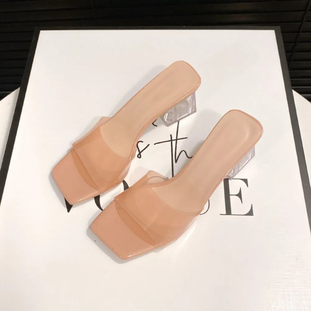 Apricot lucite heel square toe mules with clear block heels.