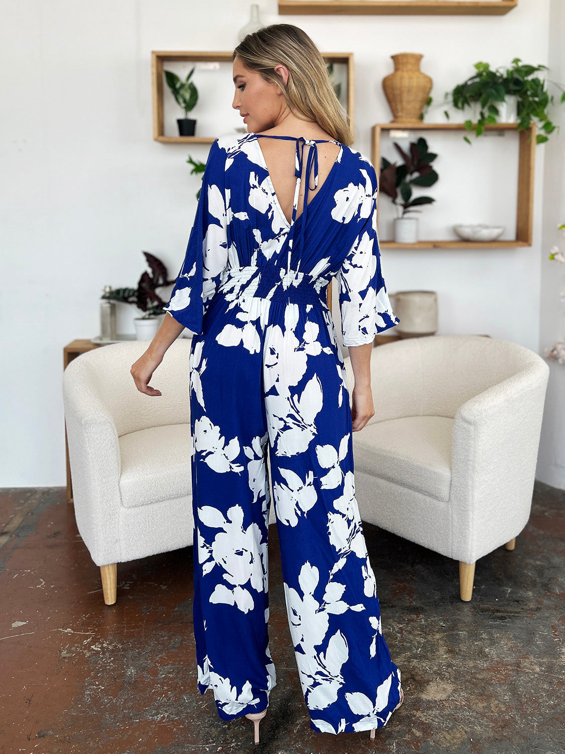 Cobalt floral kimono jumpsuit with tie back and wide legs.