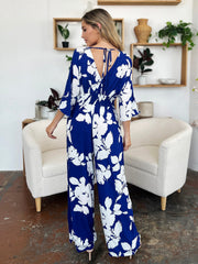 Cobalt floral kimono jumpsuit with tie back and wide legs.
