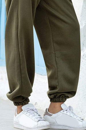 Army green sweatpants with gathered cuffs and a slouchy fit.