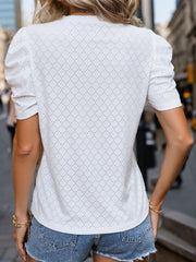 White eyelet panel puff sleeve blouse with a textured pattern.