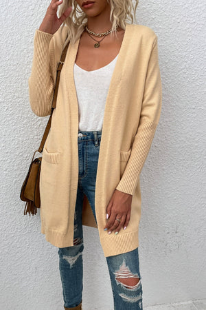 Khaki ribbed cuff open-front cardigan with pockets, styled with jeans.