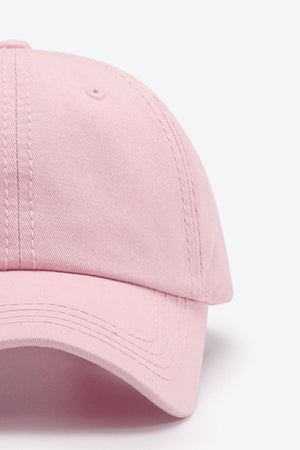Pink canvas baseball cap with stitched details and eyelet.