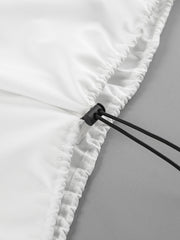 White two-piece set detail with drawstring and snap closure