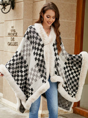 Checkered acrylic cape with faux fur trim in black and white, open front, cozy winter outerwear.