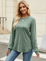 Sage crew neck top with vertical seam detail and long sleeves.