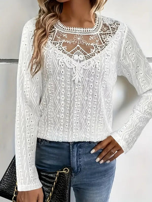 White eyelet embroidered blouse with lace yoke and long sleeves.