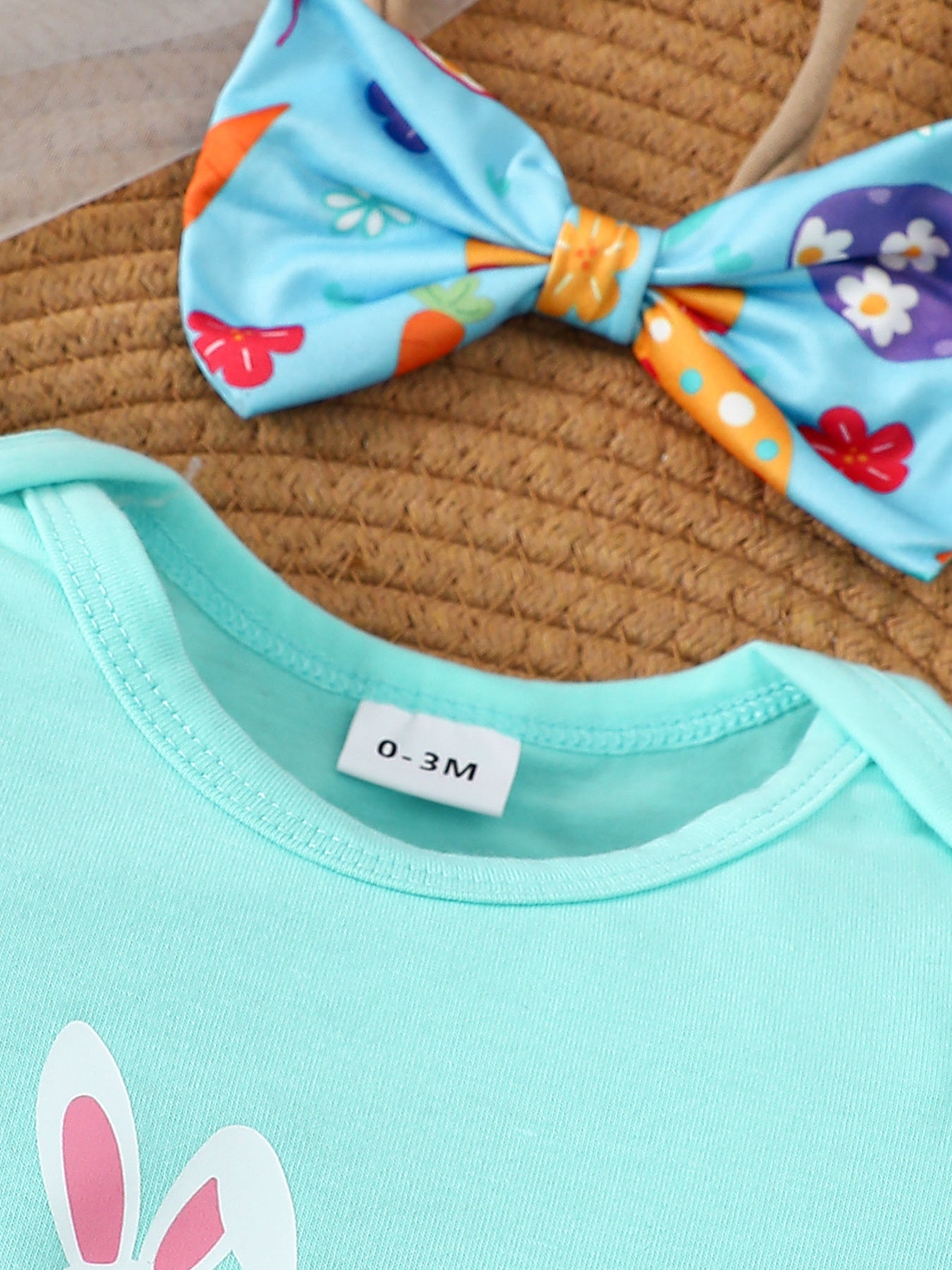 Lake blue cotton bodysuit with Easter carrot and egg print bow headband.