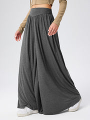 Dark gray jersey wide-leg trousers with a drape-front and elastic waistband.