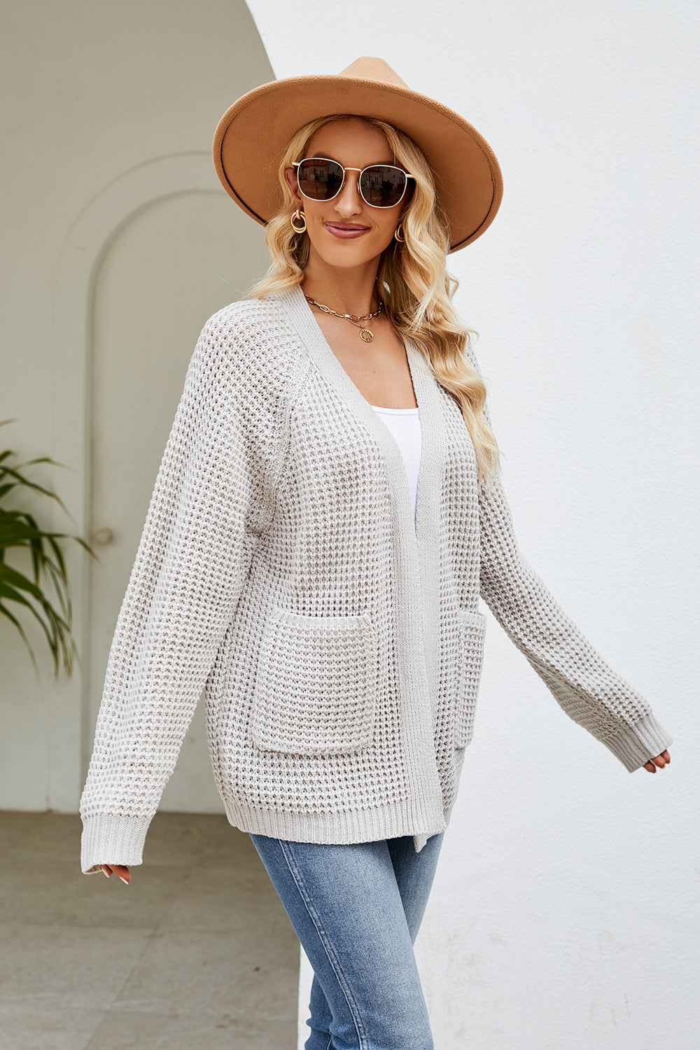 Light Gray waffle knit raglan pocket cardigan with open front and long sleeves.
