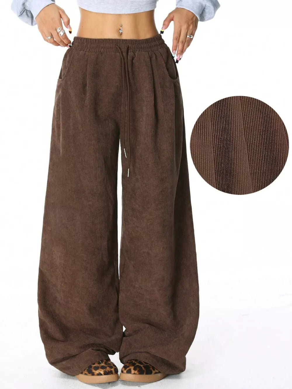 Brown corduroy maternity trousers with wide legs and drawstring waist.
