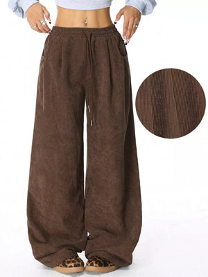 Brown corduroy maternity trousers with wide legs and drawstring waist.