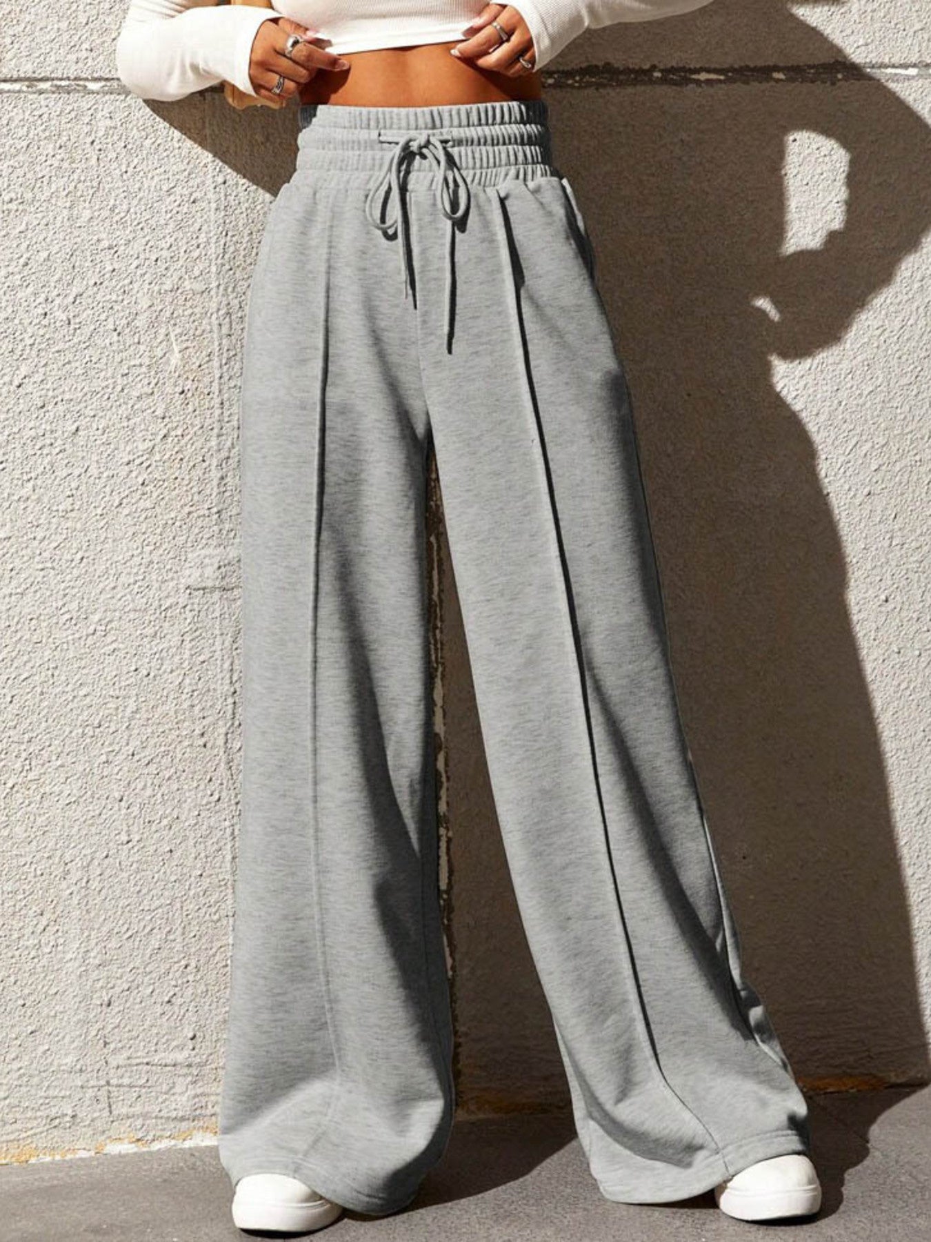 Gray wide-leg sweatpants with drawstring waist and front seam detail