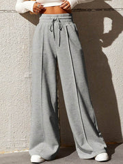 Gray wide-leg sweatpants with drawstring waist and front seam detail