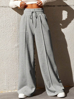 Gray wide-leg sweatpants with drawstring waist and front seam detail